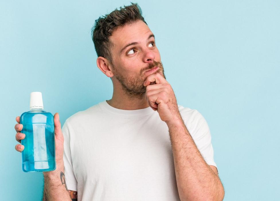 A man with a bottle of mouth wash in Annapolis, MD