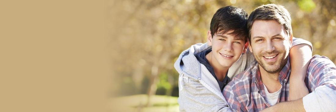 Father and son smiling after dental treatment at Chesapeake Bay Dentistry