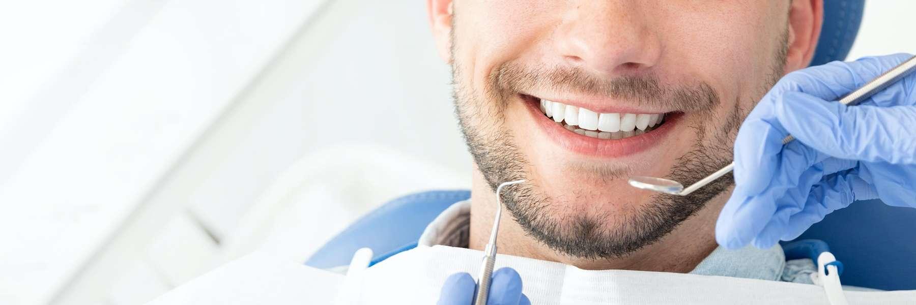 Man smiling during emergency dental examination at Chesapeake Bay Dentistry