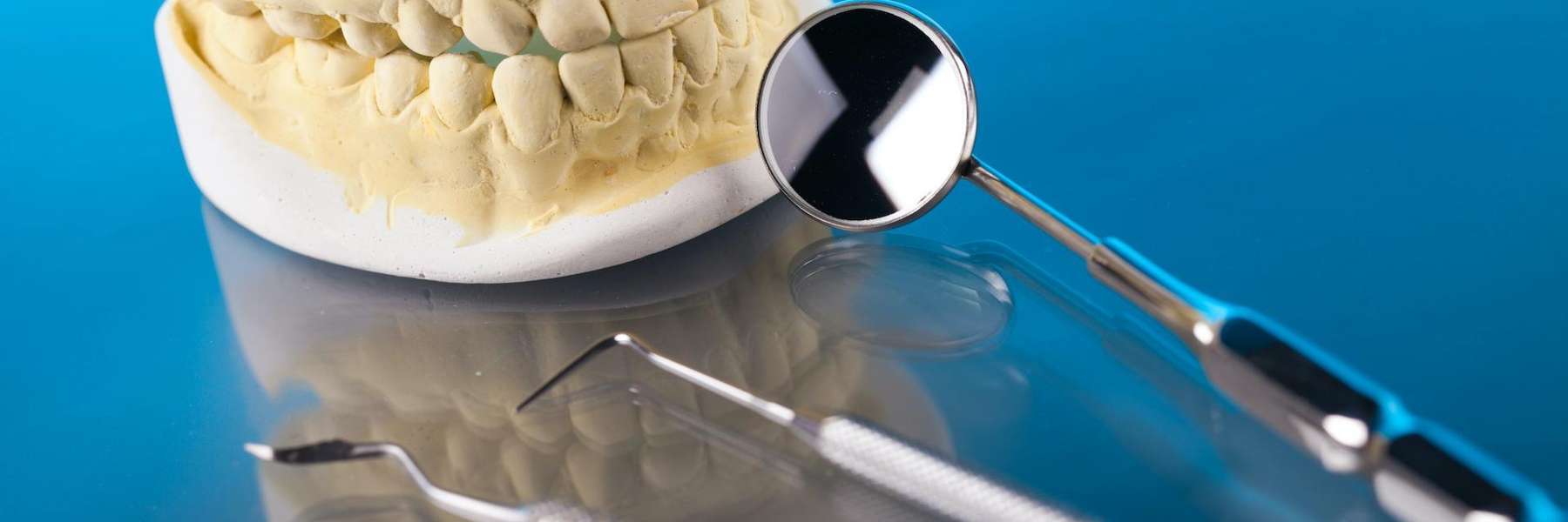 A picture of a dental crown and teeth extraction tools in Annapolis, MD