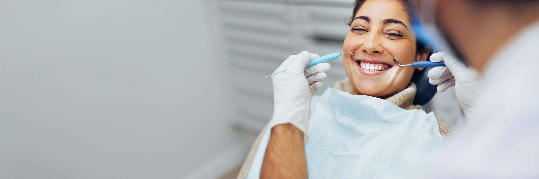 Lady smiling during tooth extraction in Annapolis, MD