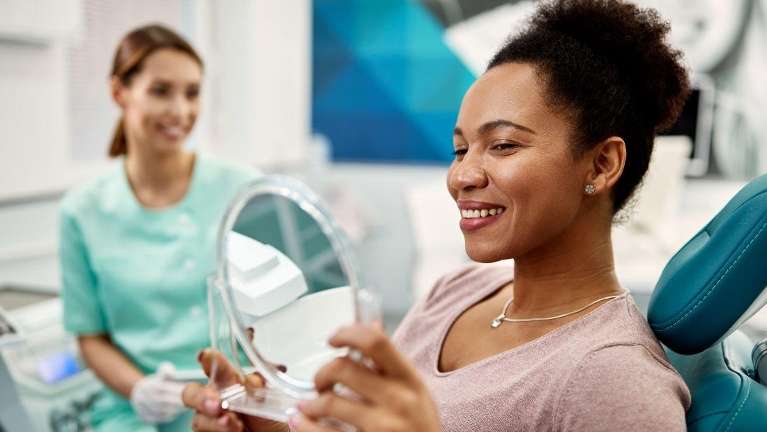 A lady smiling after dental crown in Annapolis, MD.