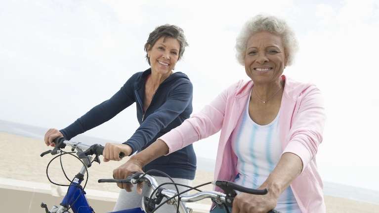 Friends riding bicycles after emergency dental treatment at Chesapeake Bay Dentistry