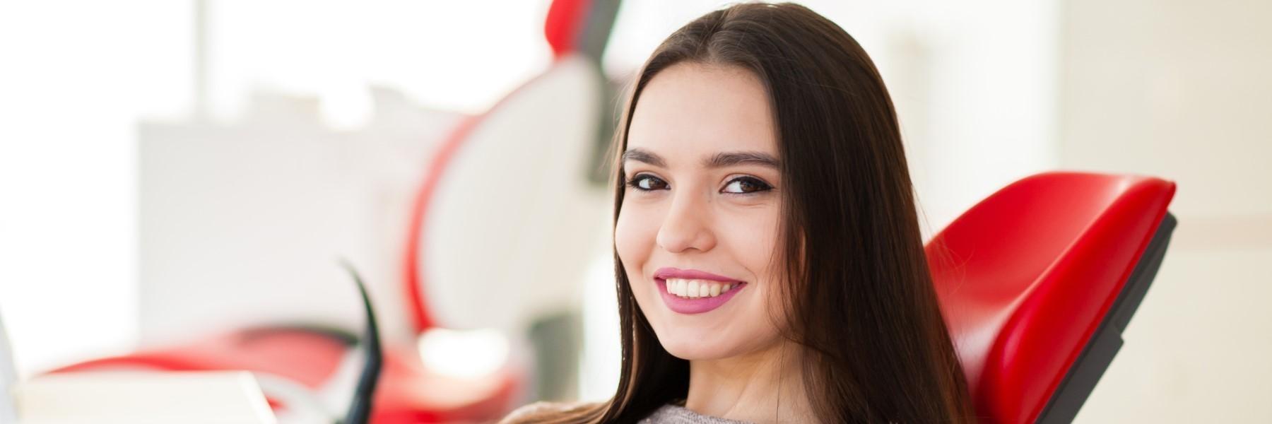 Young woman smiling after professional teeth whitening in Annapolis, MD